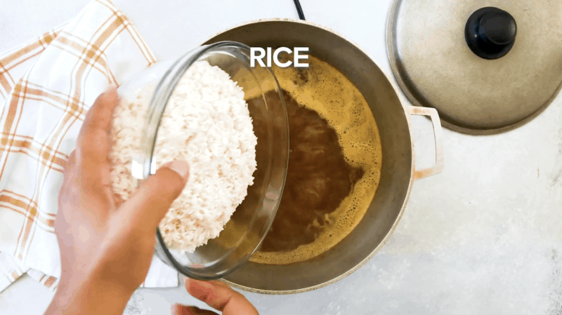 Rice being added to the pan.