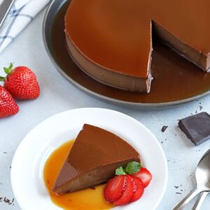 Chocolate plan served on a plate with a sliced strawberry.