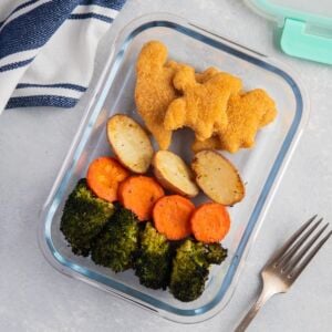 Yummy Dino Buddies with roasted vegetables on a glass food container