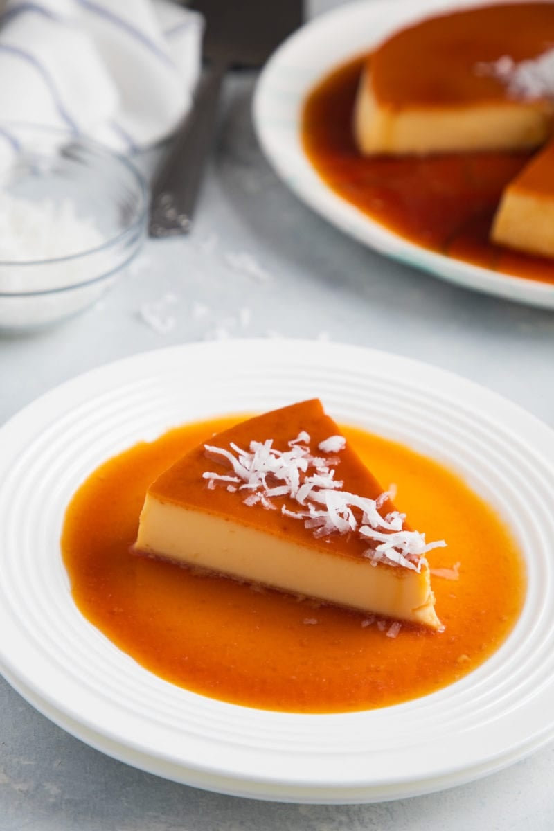 A slice of the flan on a white plate