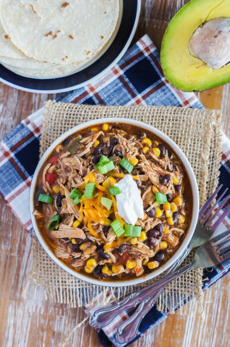 Slow cooker taco chicken chili served in a bowl with sour cream