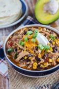 Slow cooker taco chicken chili in a blue and white bowl with toppings