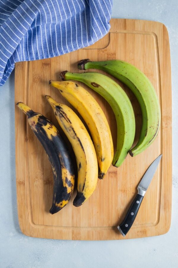Plantains on a wooden chopping board