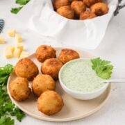 Yuca balls and dip served on a plate
