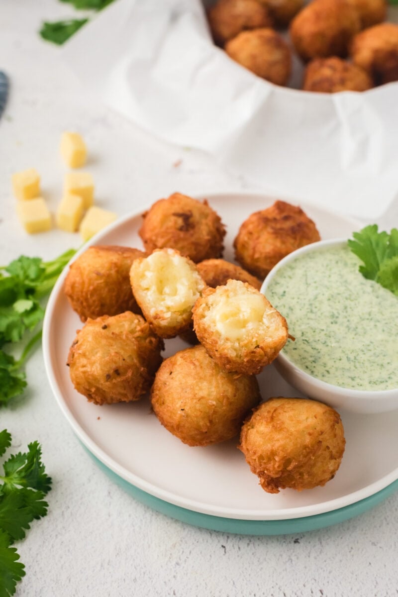 Stuffed yuca balls served with a dip and fresh cilantro