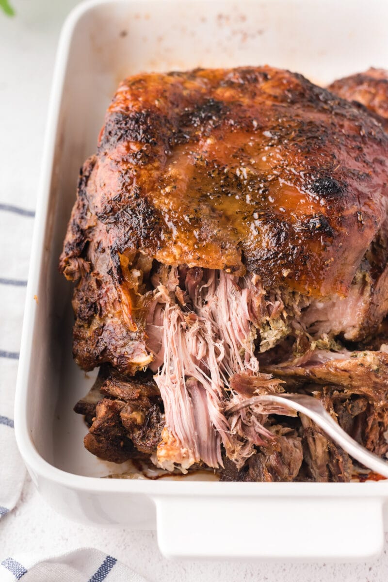 Close up of the pork being shredded with a fork.