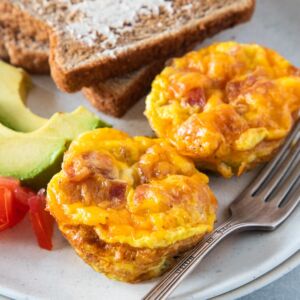 Close up of Bacon and Egg Muffins served with toast and avocado