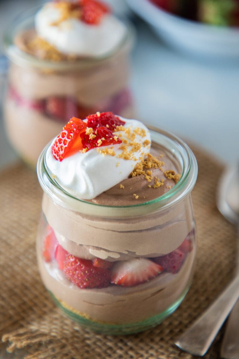 close up of chocolate and strawberry cheesecake parfait