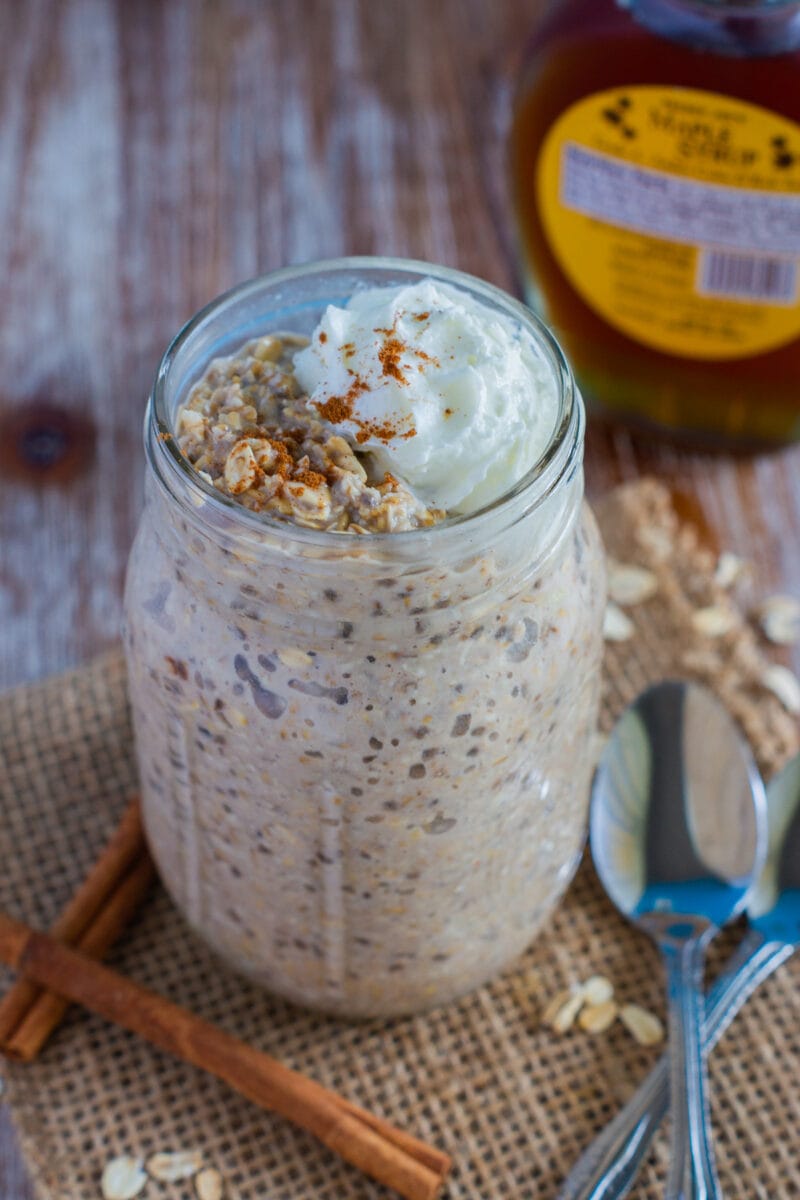 Overnight Oats served in a mason jar topped with whipped cream. 
