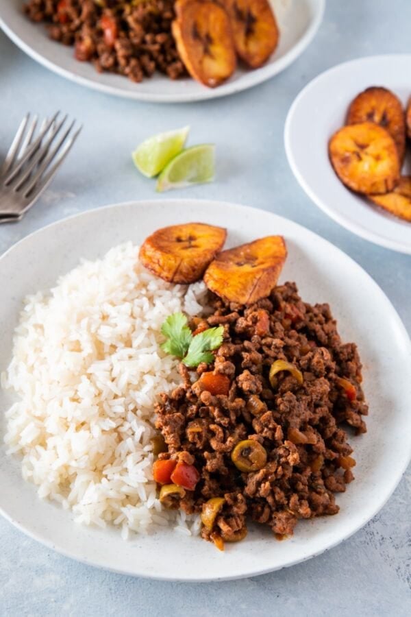 Picadillo served with rice and plantains on the side ready to eat