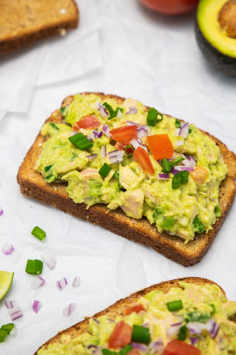 close up of tuna avocado salad on toast