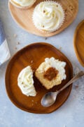 Almond cupcake split open in half with dulce de leche in the middle