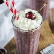 Chocolate Cherry Smoothie in a glass topped with a cherry