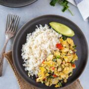 Bacalao con huevos served on a gray plate ready to eat
