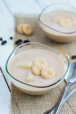 Habichuelas con Dulce served on a glass bowl and topped with biscuit cookies