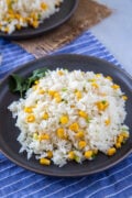 Rice with corn (arroz con maiz) served on a plate with forks on the side