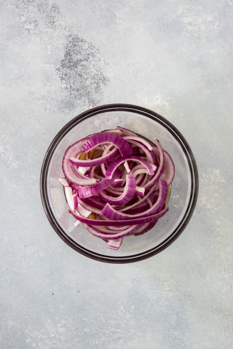 A bowl of sliced red onions.