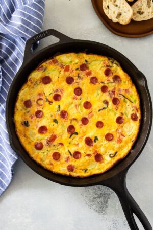 Pizza Frittata in a skillet with bread on the side