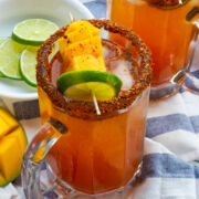 Mango Michelada served in a glass with mango and lime garnish.