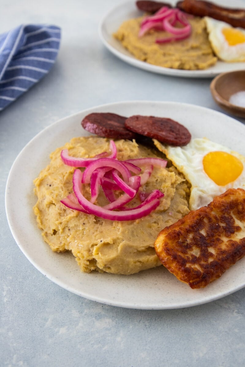 Dominican Food Mangu with los tres golpes on a white plate