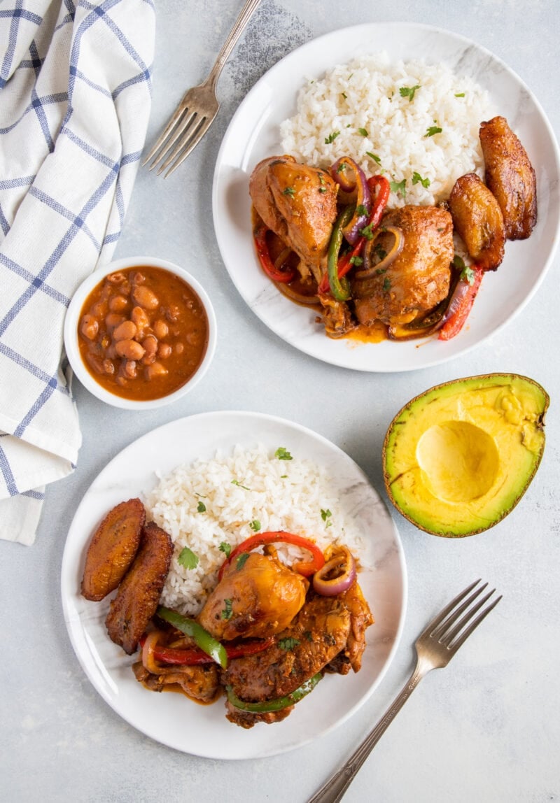 Dominican Food La Bandera - Pollo guisado, white rice and beans with avocado on the side