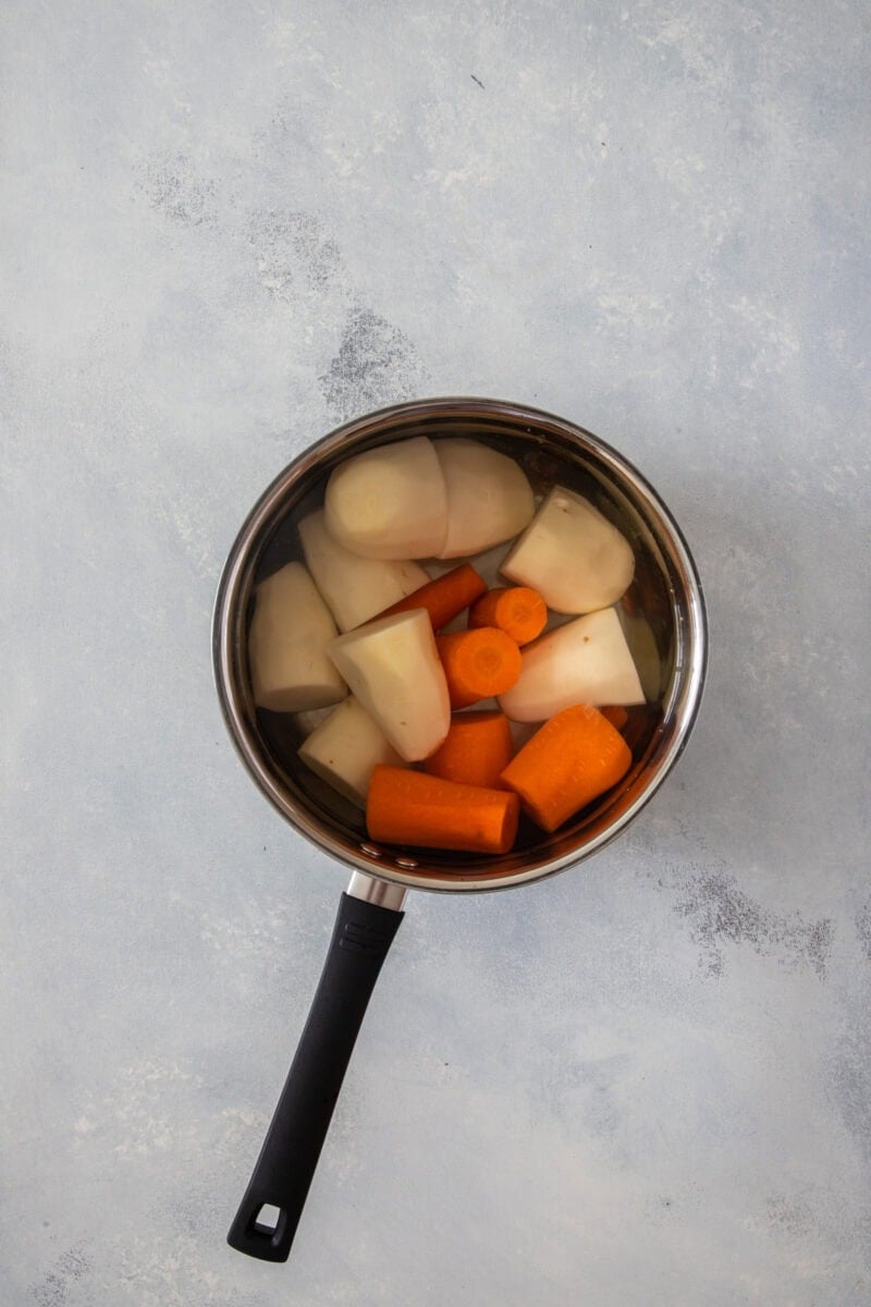 Carrots and potatoes in a pot with water ready to boil