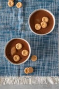 overhead photo of two bowl of habichuelas con dulce topped with cookies