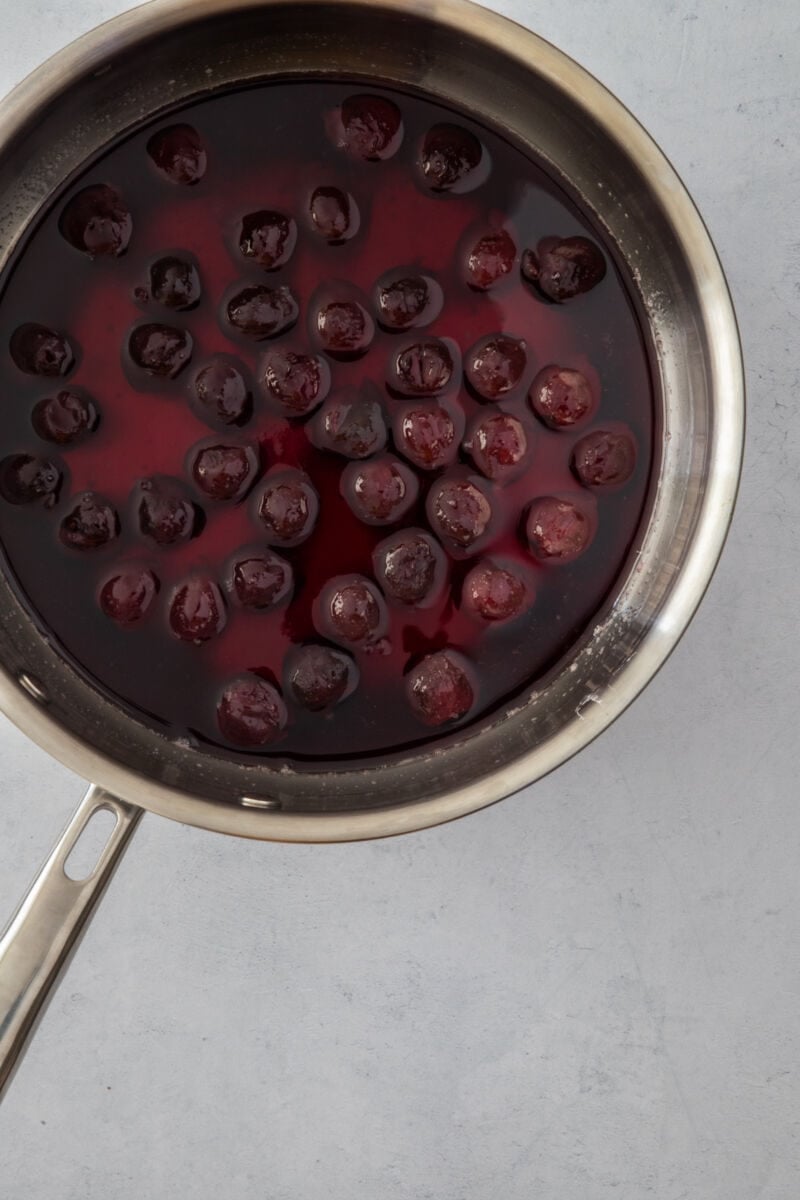 Cherry syrup cooking in a saucepan