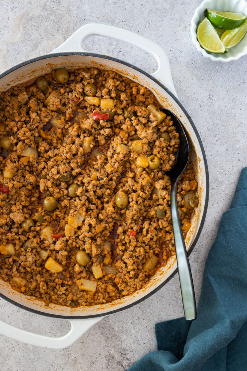 Minced Pork with serving spoon and lime wedges on the side