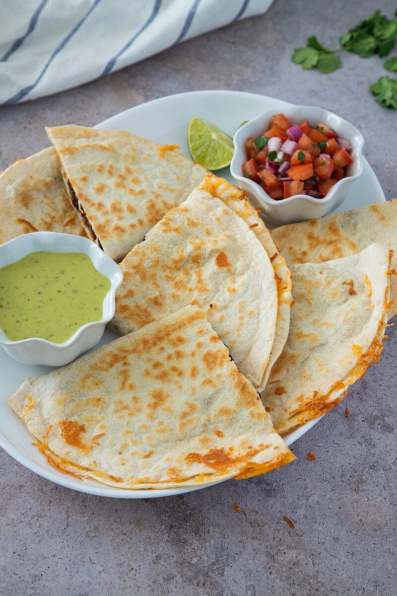 Beef Quesadilla cut in quarters on a white platter