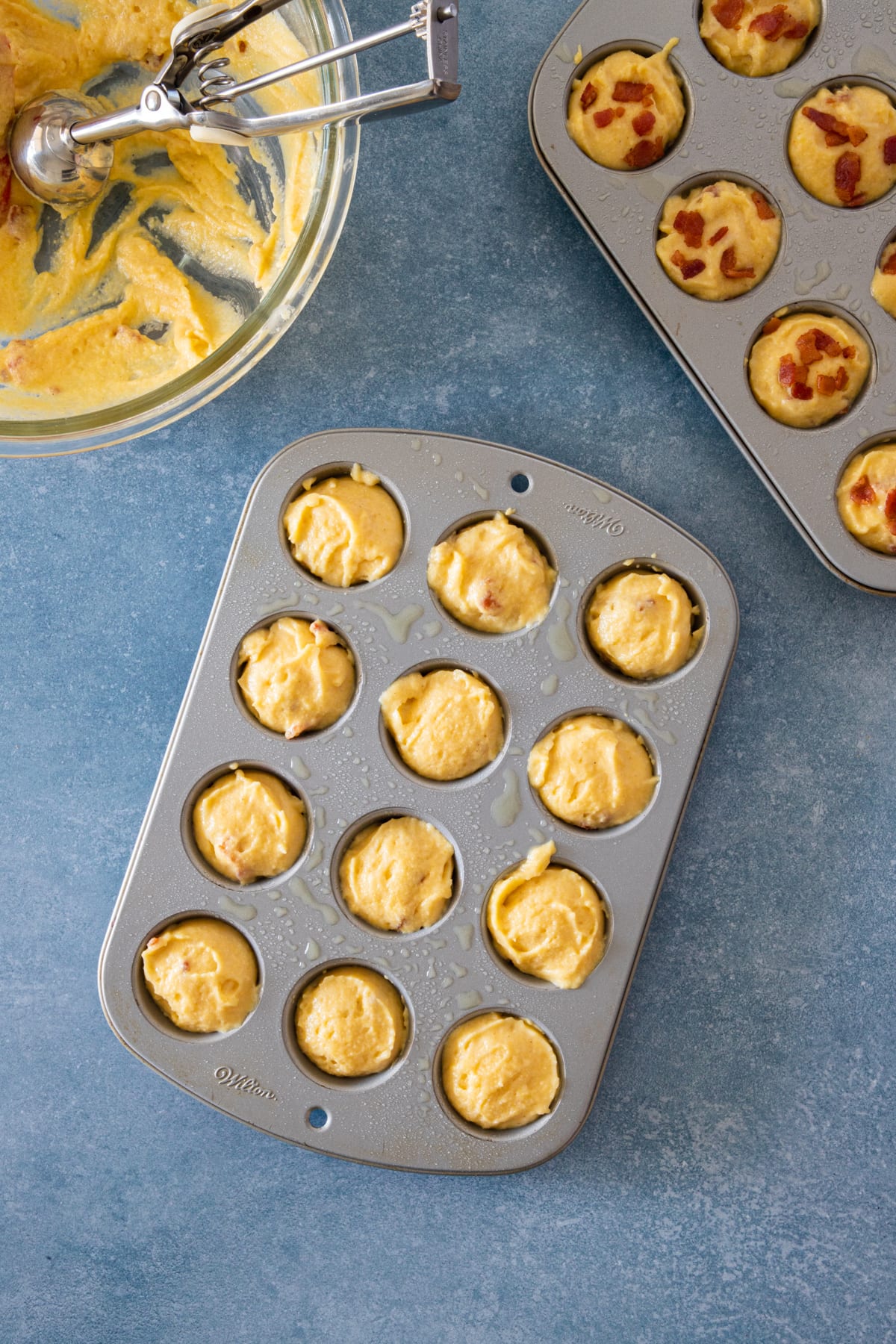 uncooked batter in mini muffins baking pan