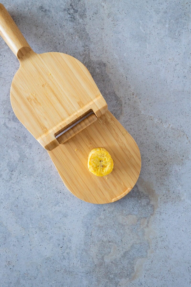 After the first fry, the plantain slices are gently pressed to create their classic shape. This step is key to achieving the perfect balance of a crispy exterior and a soft, tender interior that makes tostones so irresistible.