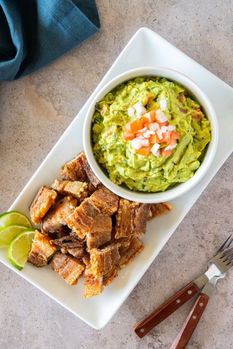 Crispy chicharrón served with creamy guacamole—perfectly golden bites with a flavorful dip.