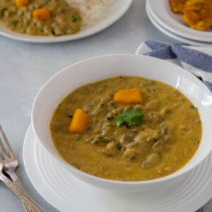 Rice with creamy guandules con coco and tostones.