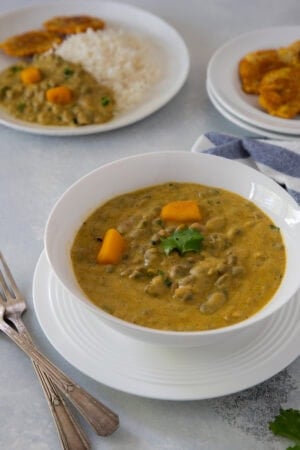 Rice with creamy guandules con coco and tostones.