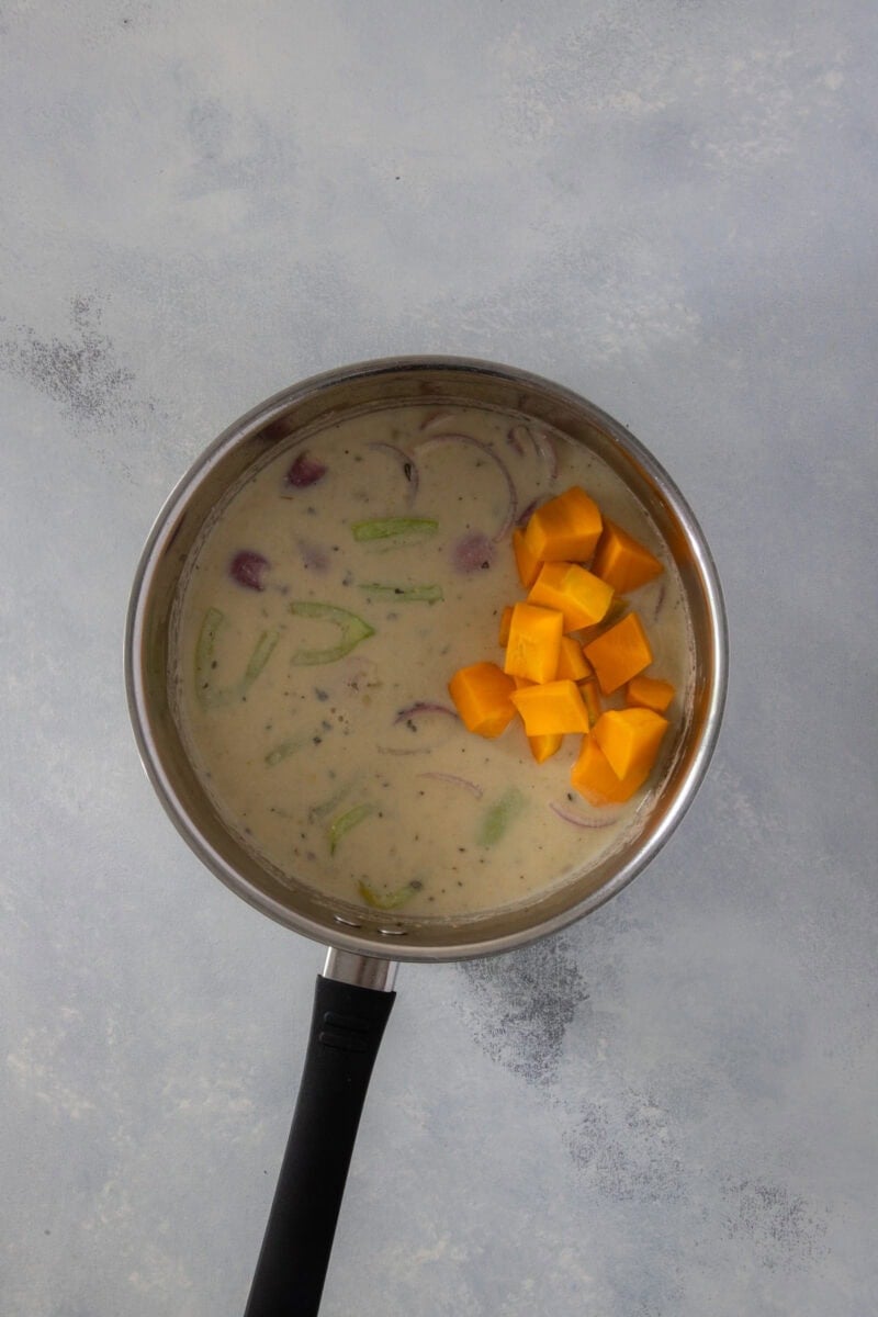 Pumpkin cubes added to creamy coconut pigeon peas.
